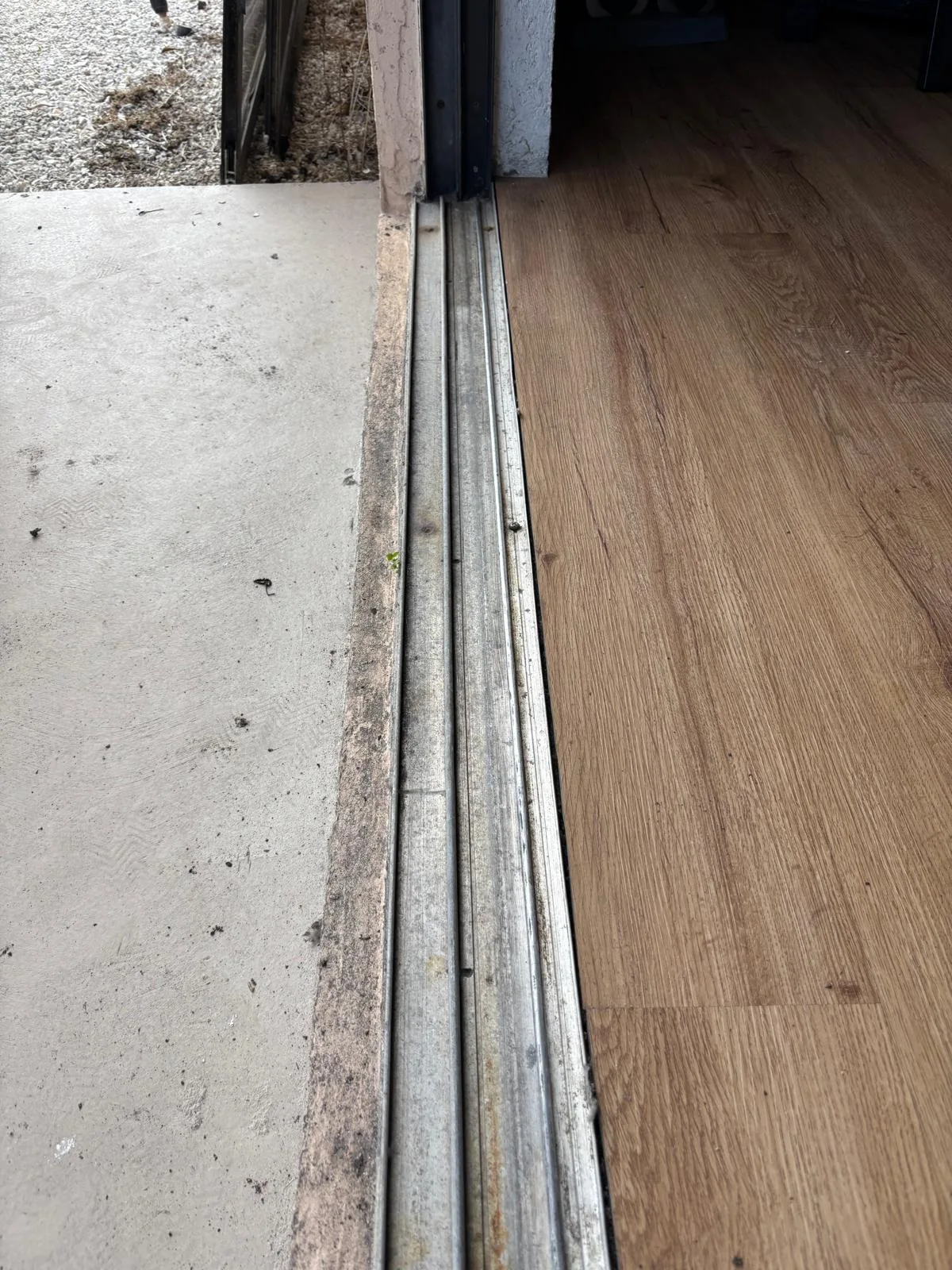 Cleaning sliding door track before weatherstripping installation