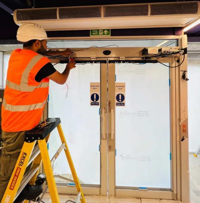 Technician diagnosing an automatic door sensor in Port St. Lucie