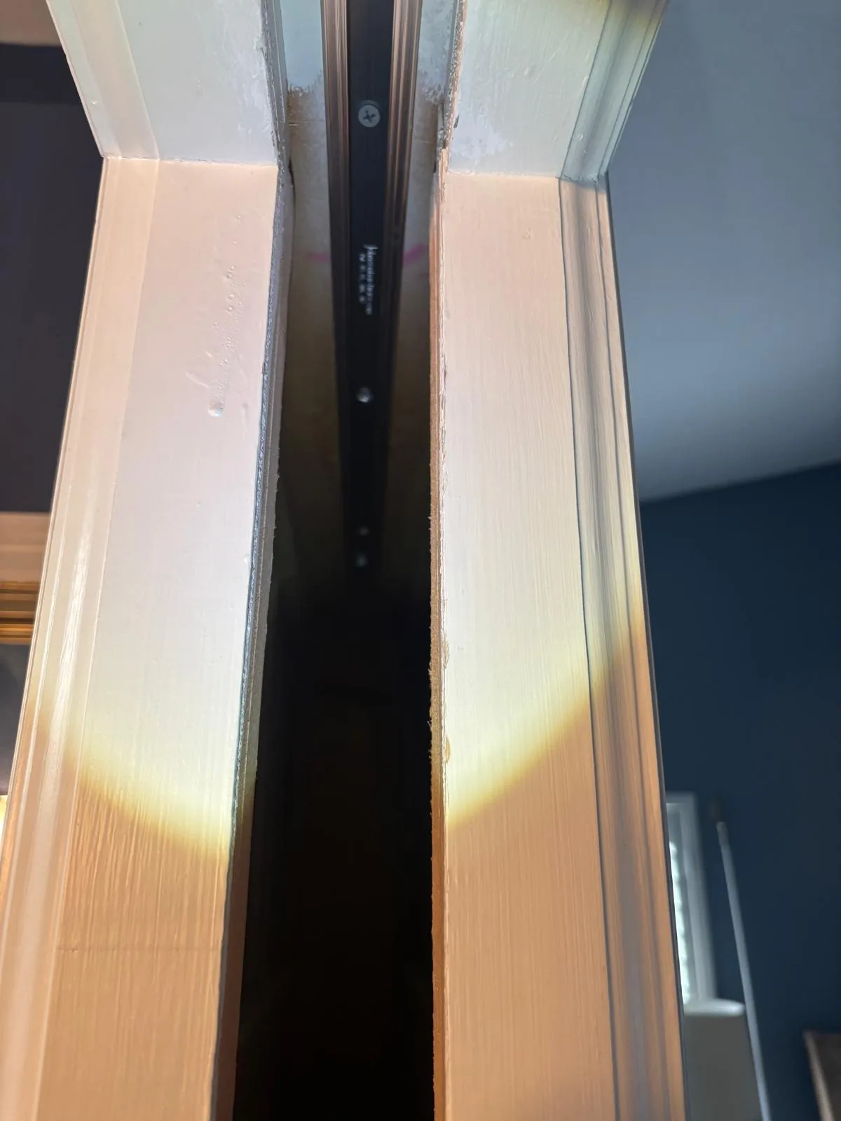 Professional pocket door roller replacement in progress