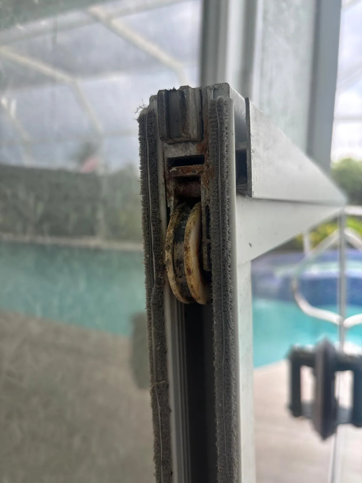 Old worn sliding door roller that needs replacement