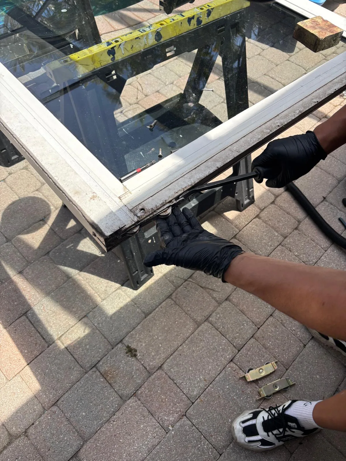 Removing worn rollers from a hurricane impact sliding door