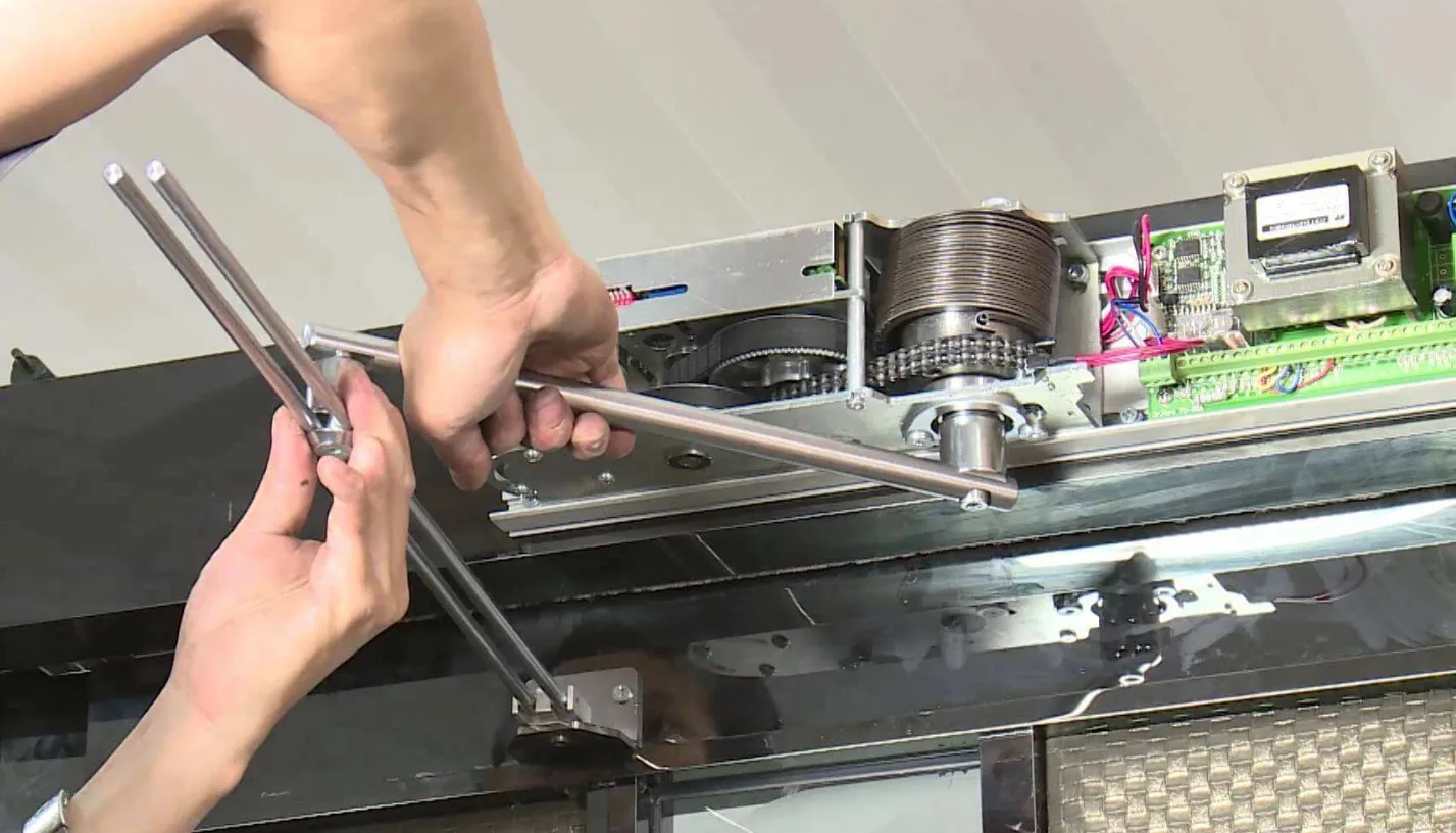 Technician inspecting automatic door motor and drive unit