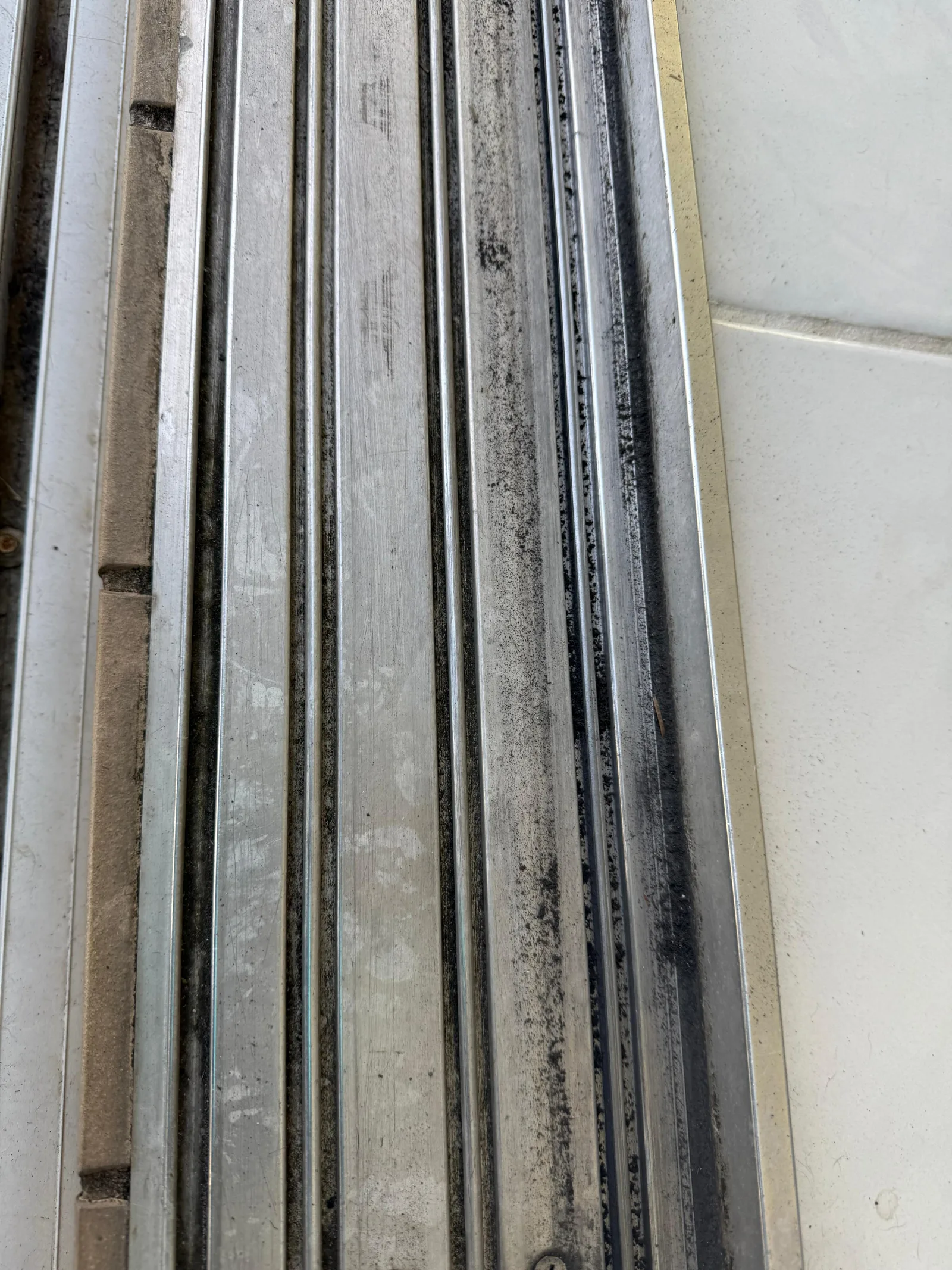 Dirty sliding door track that needs repair Dirty sliding door track that needs repair